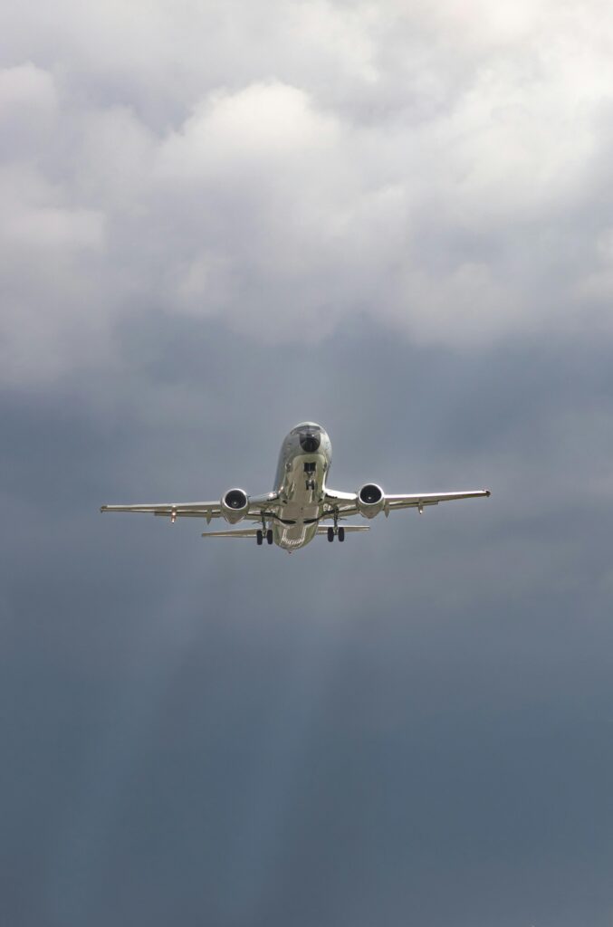 A commercial airplane flying through a cloudy sky in Bogotá, Colombia, capturing the aviation essence.