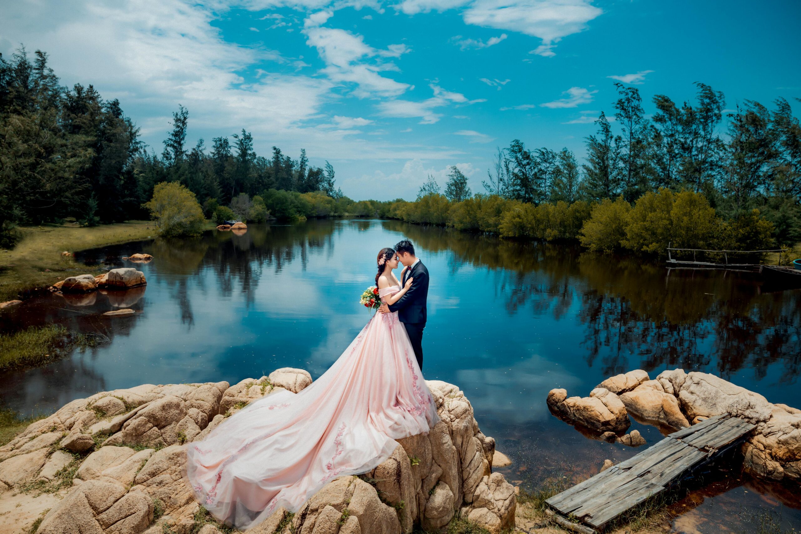 A romantic pre-wedding scene by a serene lake, capturing the couple's love amidst nature.