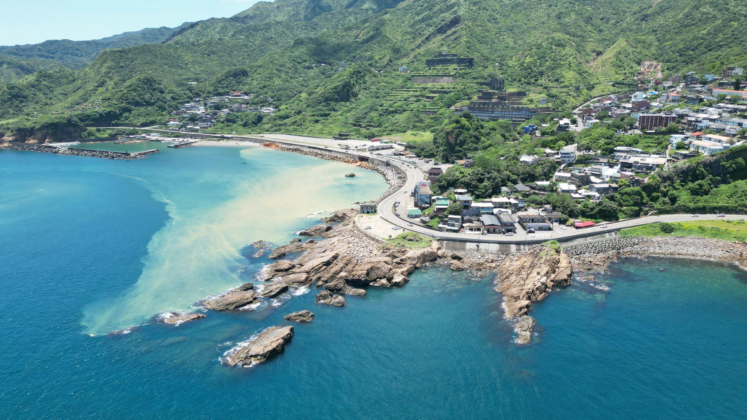 Aerial view of Taiwan's lush coastline with vibrant blue oceans and picturesque landscape.