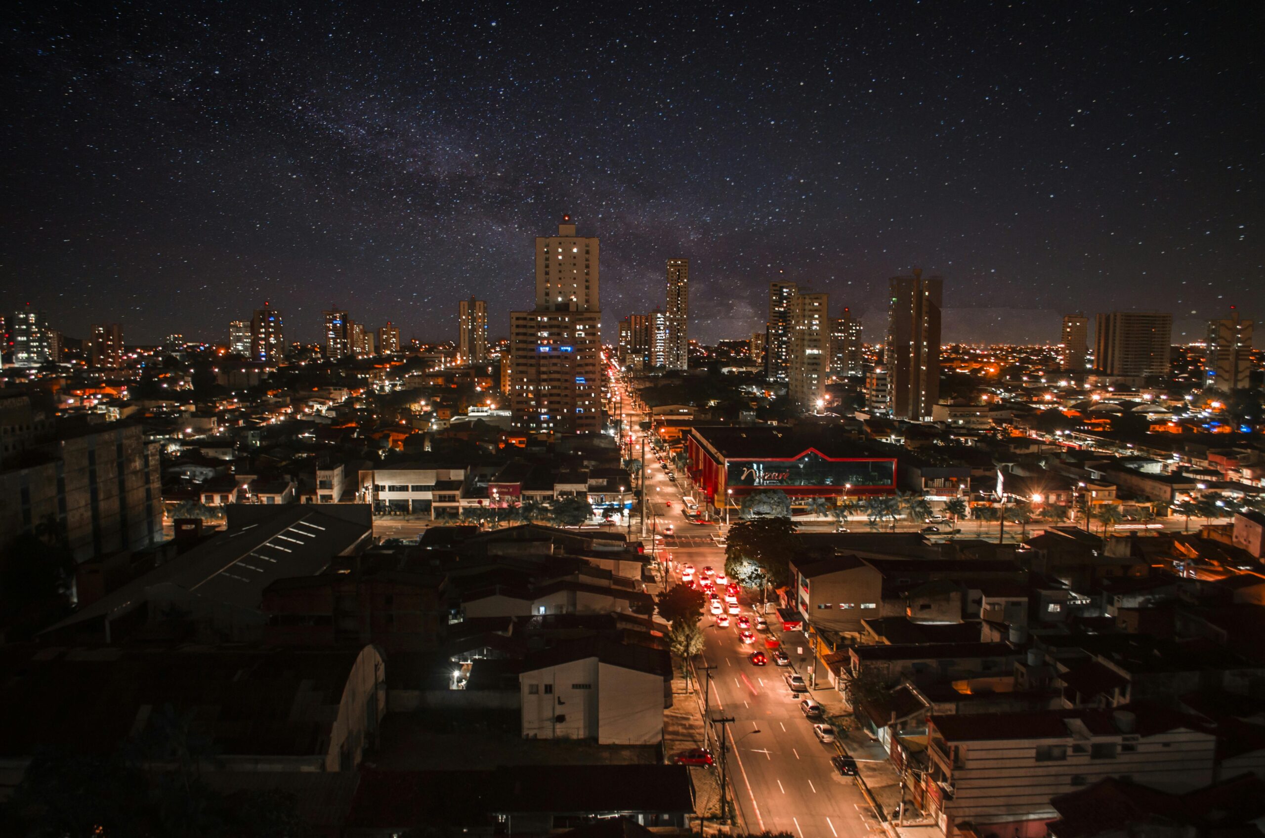 Captivating night cityscape of Nazaré, Brazil, showcasing vibrant urban lights and a starry sky.