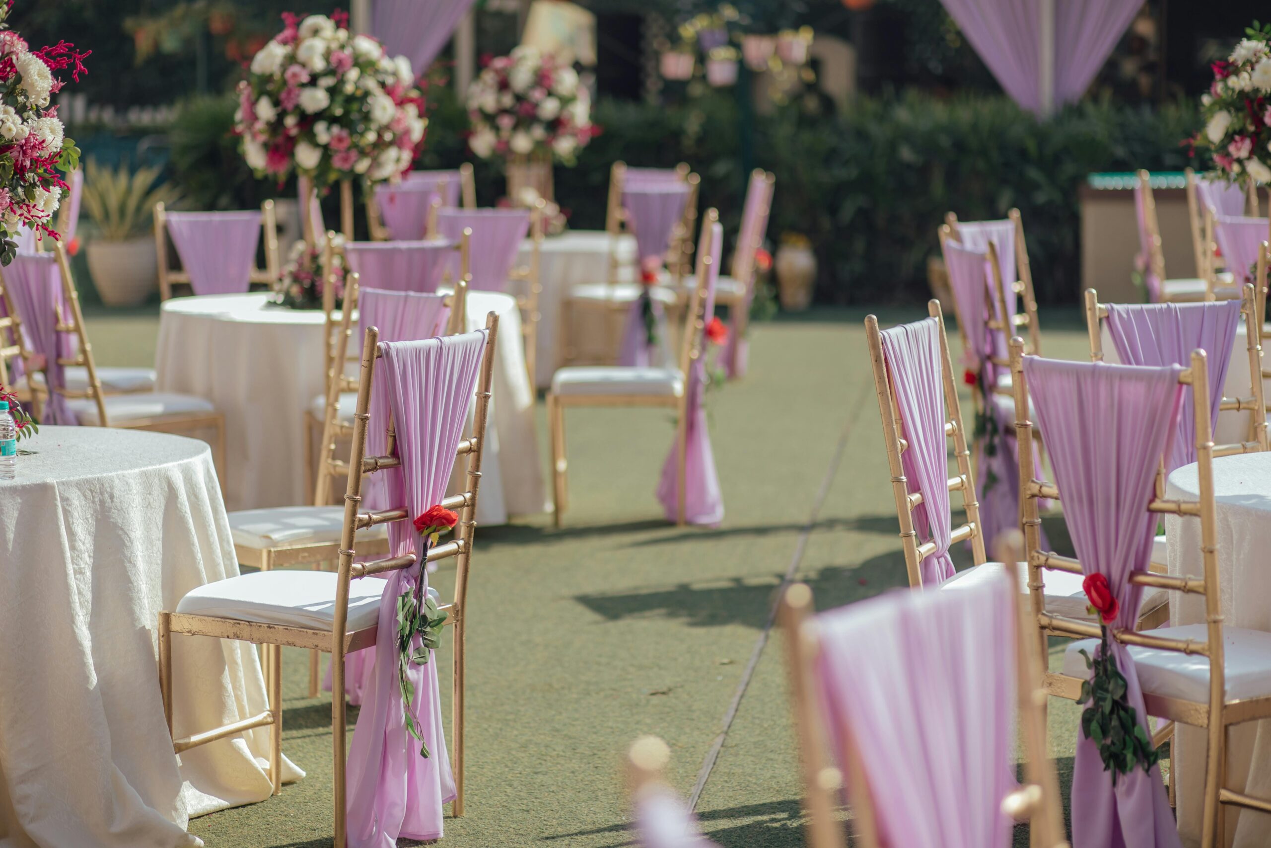 Charming outdoor wedding reception with elegant floral arrangements and pastel decorations.