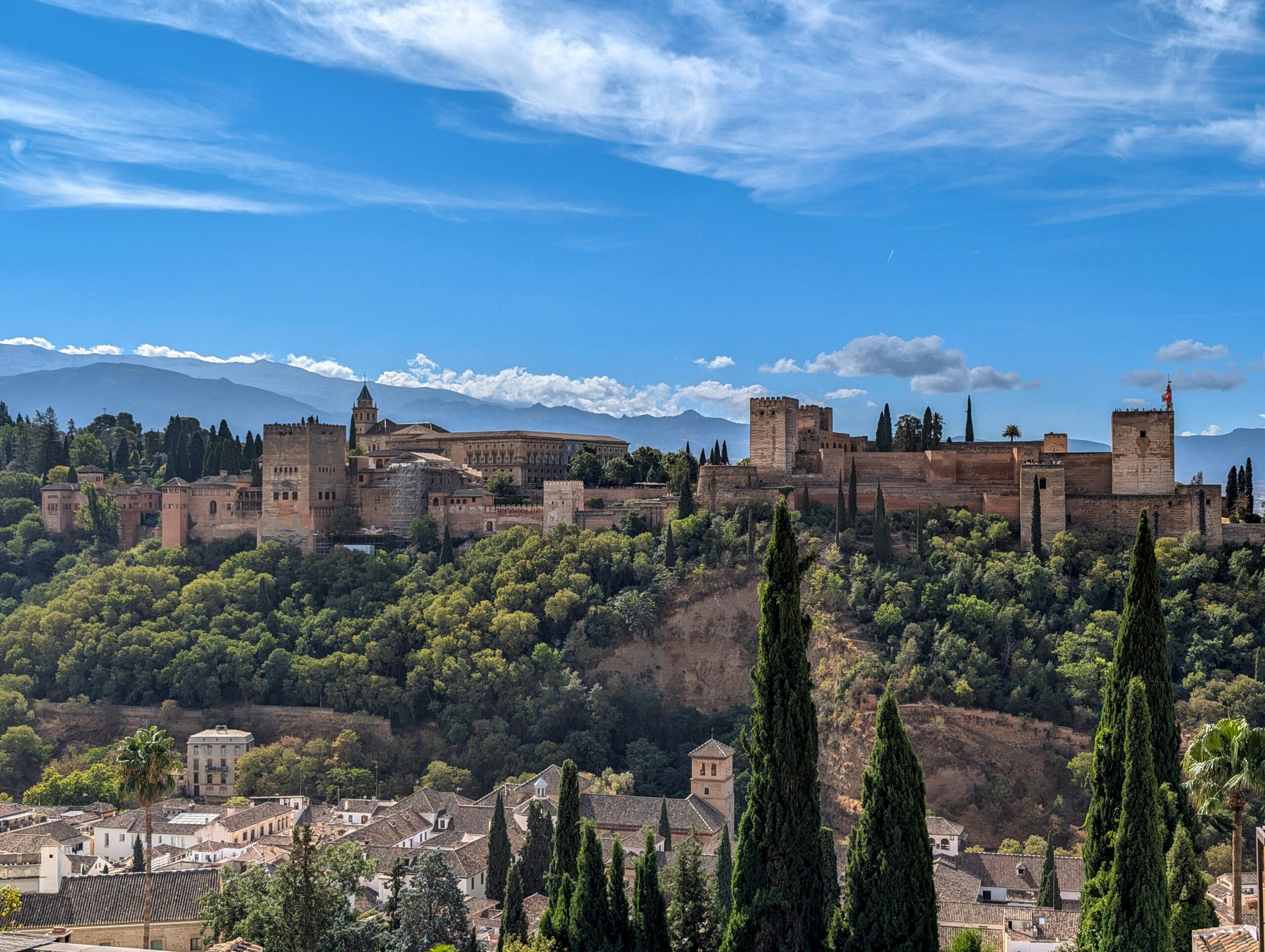 Stunning view of the Alhambra Palace against the clear blue sky in Granada, Spain.