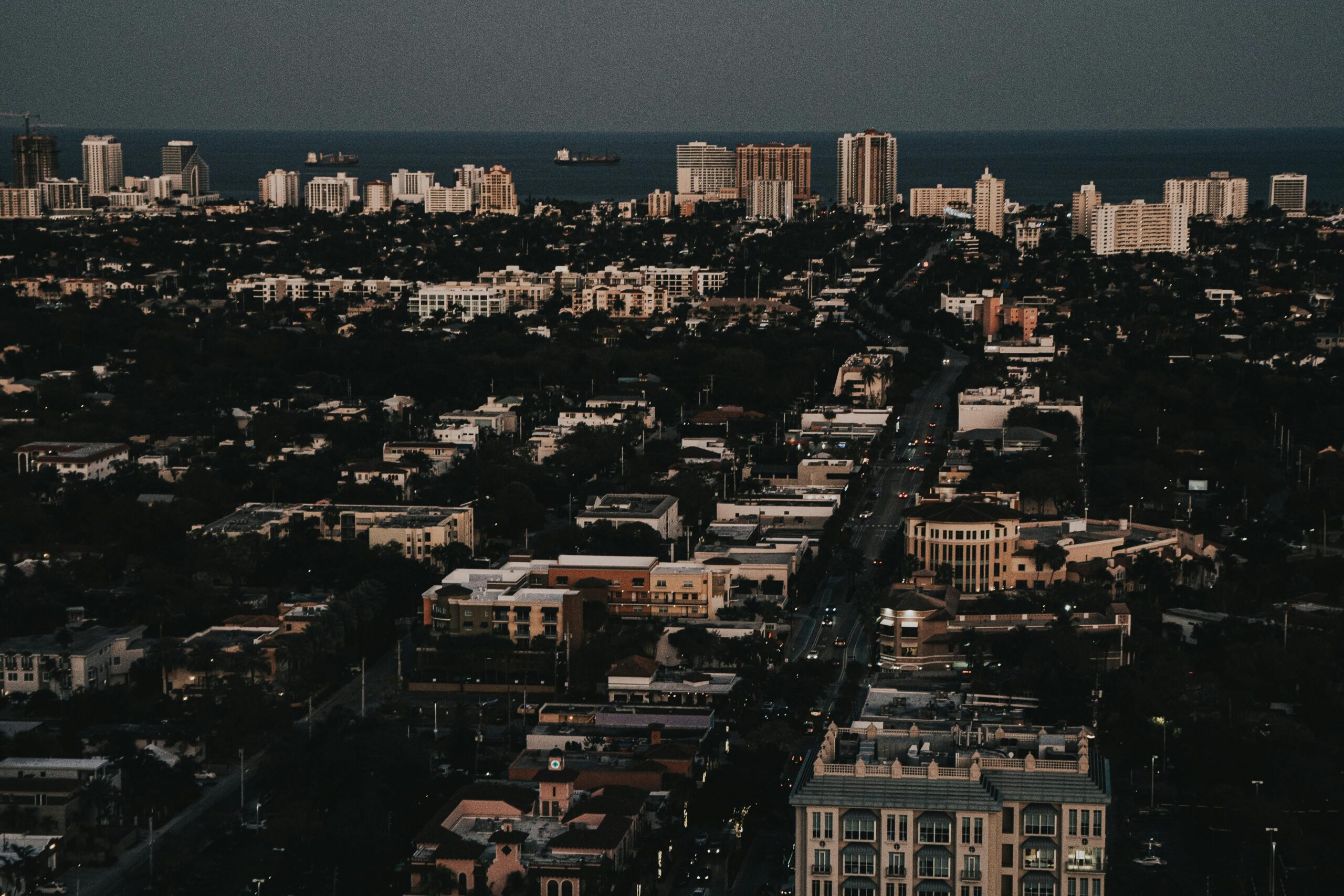 Stunning aerial cityscape of Fort Lauderdale, highlighting the urban skyline and ocean view during twilight.
