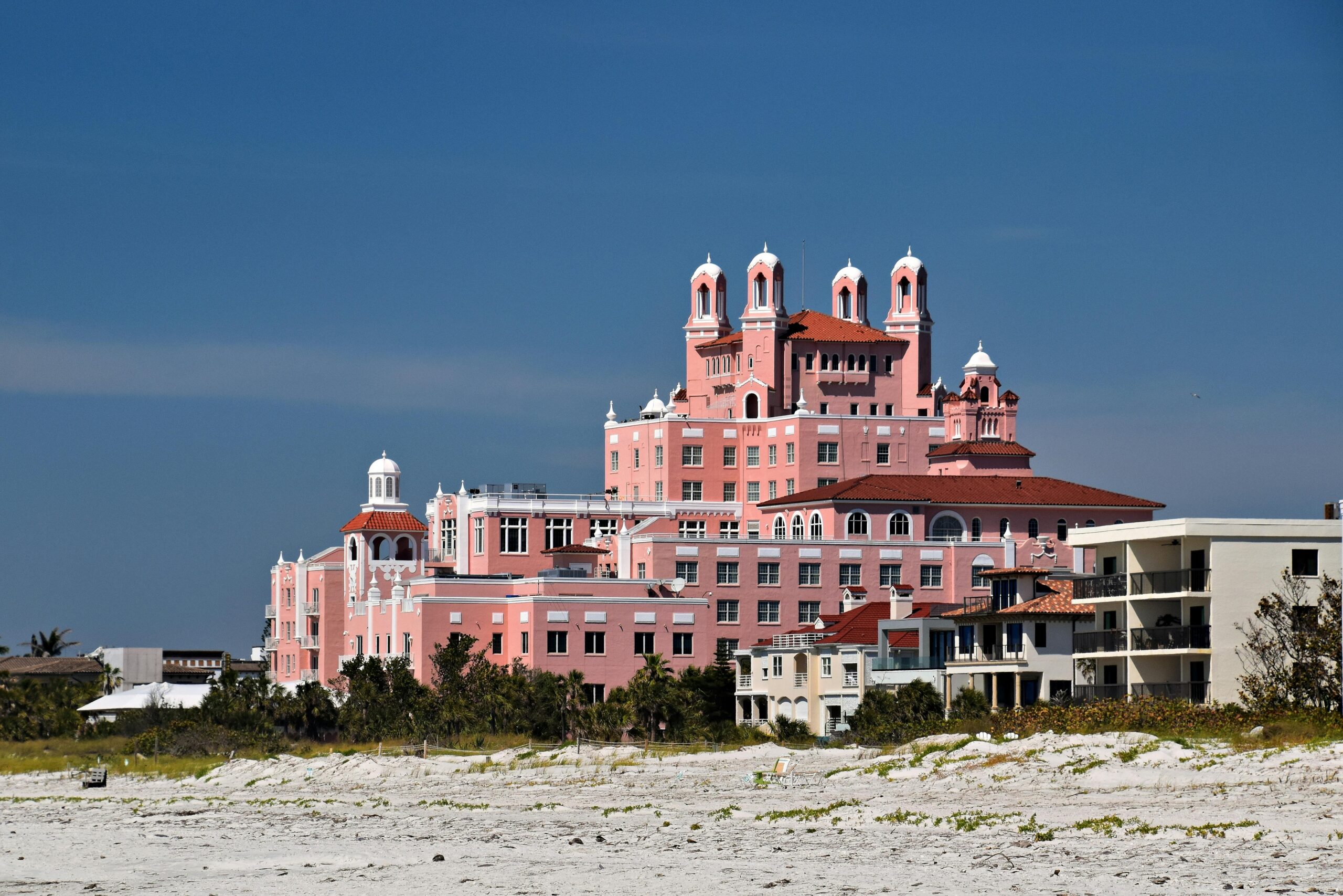 View of the iconic Don CeSar Hotel on St. Pete Beach against clear blue skies.