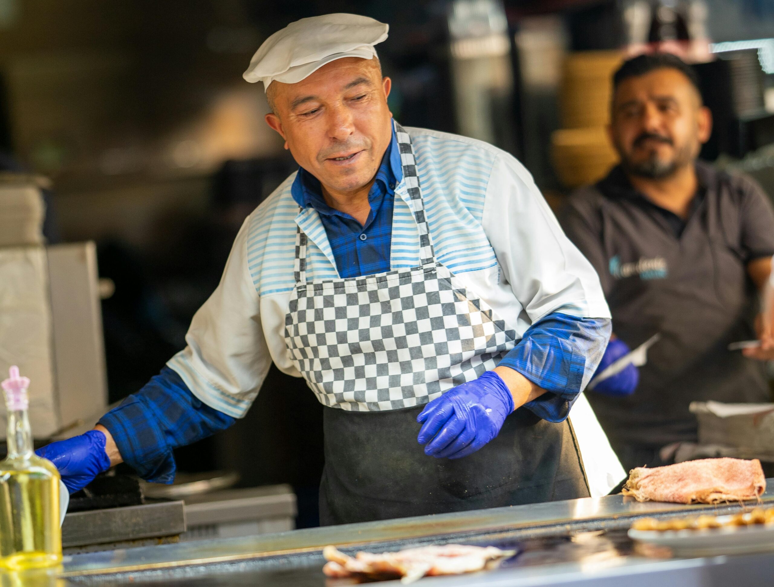 A street vendor in Kayseri, Türkiye, cooking traditional food with a focus on fresh ingredients.